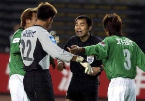 Guoan players argue with the referee