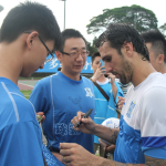 Rafael Coelho signs autographs after the open training session