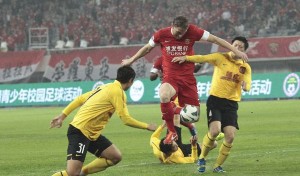 Fighter: Gary McBreen, pictured here against Guangzhou Evergrande in 2013, wants to keep his career in going