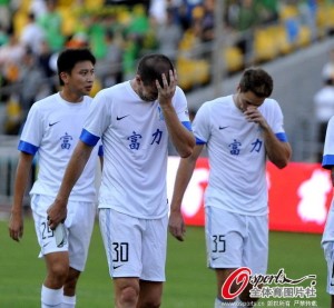 Disappointed Guangzhou R&F players leave the field after loosing to Beijing