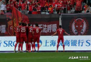 Daniel McBreen is mobbed whilst Wu Lei celebrates in front of the home fans.