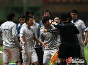 Dalian subs and coaches protest against the awarding of the penalty after Davi had already scored it