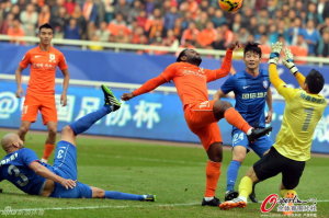 Ouch: The ball deflects off Vagner Love's face and wide during Shandong's early spell of pressure