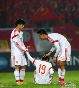 No Pain No Gain: Wu Lei is helped to his feet by Gao Lin (18) and Hao Junmin (11) after being injured while scoring the second goal