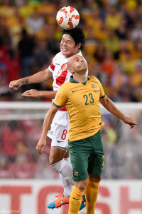 Midfield Warriors"Cai Huikang and Mark Bresciano battle for the ball