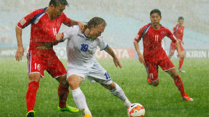 Wash Out: Uzbekistan's game against North Korea was played in horrendous weather conditions 