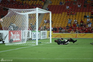 Down And Out: Saudi goalkeeper, Waleed Abdullah, had no chance of stopping Yu Hai's freekick