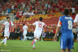 Class Act: Wu Xi celebrates his equalizer against Uzbekistan