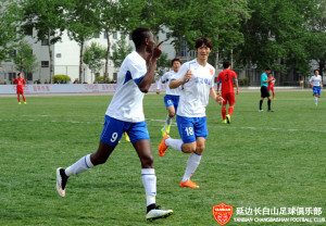 Yanbian striker Steve celebrates scoring against BIT.