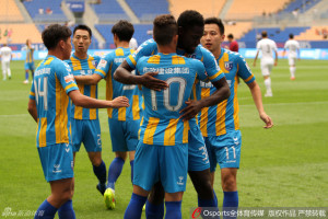 Welcome To Tianjin: Debuting goal scorer Frank Nouble gets a hug from Mario Lucio