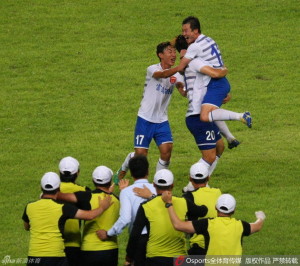 Yanbian players celebrate Cui Min's (20) free kick goal