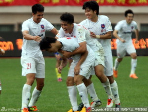 Qingdao Jonoon players celebrate Lei Quan's late goal.