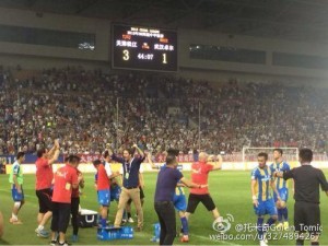 Songjiang players and staff celebrate their third goal