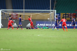 Pak Hyon-il (centre) runs off to celebrate after headin North Korea in front against Japan