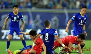 Dalian and Yanbian players tussle for the ball