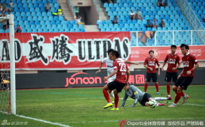 Hebei's Yang Cheng saves at the feet of