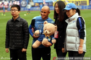 Dalian's nineteen goal hero Bruno Meneghel (holding teddy bear) is honoured before the last match of the season