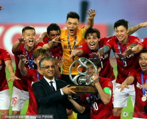 Evergrande players celebrate lifting the trophy