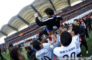 Hebei manager Li Tie celebrates promotion with his players 