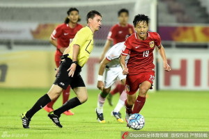 Even the referee can't stop Chang Feiya who scored China's first goal with after a neat dribble