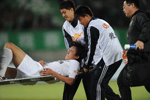 Du Wei being stretchered off