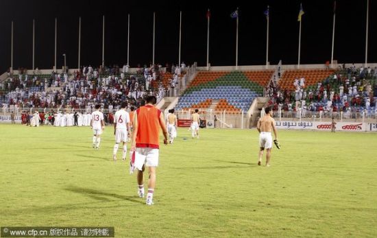 Chinese players leave the pitch dejected