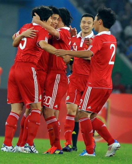 chinese players celebrate a goal